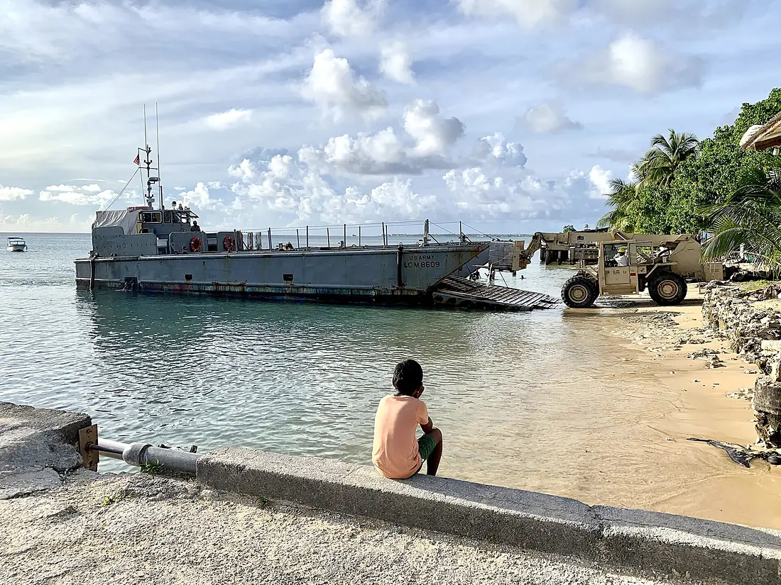 A Marshall Islander watches Seabees offload materials and tools on Kwajalein Atoll in the Republic of the Marshall Islands. (49059732531)
